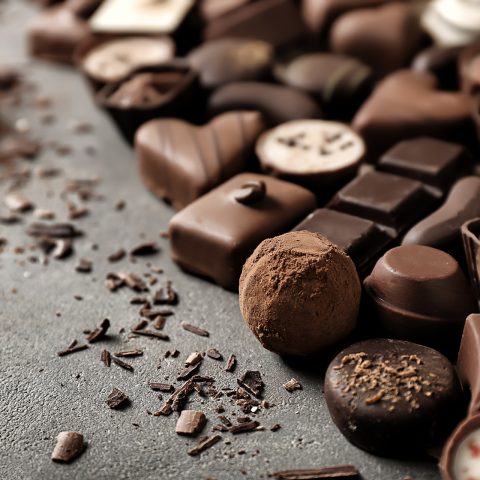 Yummy,Chocolate,Candies,On,Grey,Background